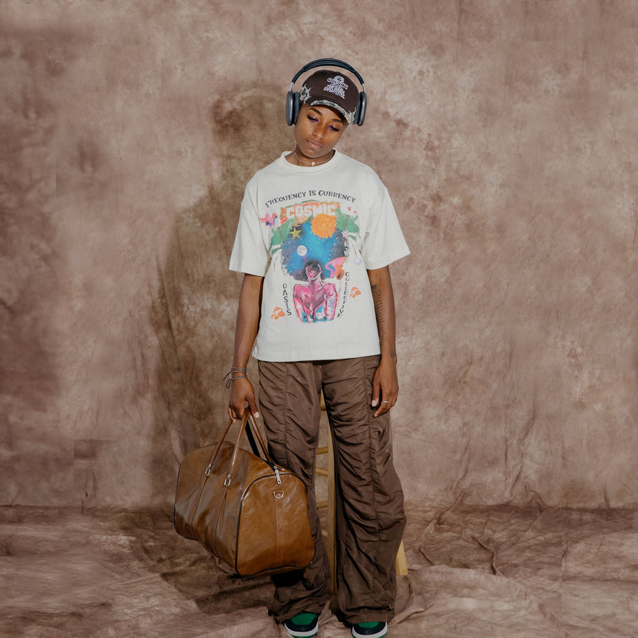 Cosmic the Oasis offers a 100% cotton t-shirt with printed Miami Pop Up graphics on front and back, available in black and champagne. Standard sizing. All cotton tees should always be washed in cold water, with delicate or line dry.
