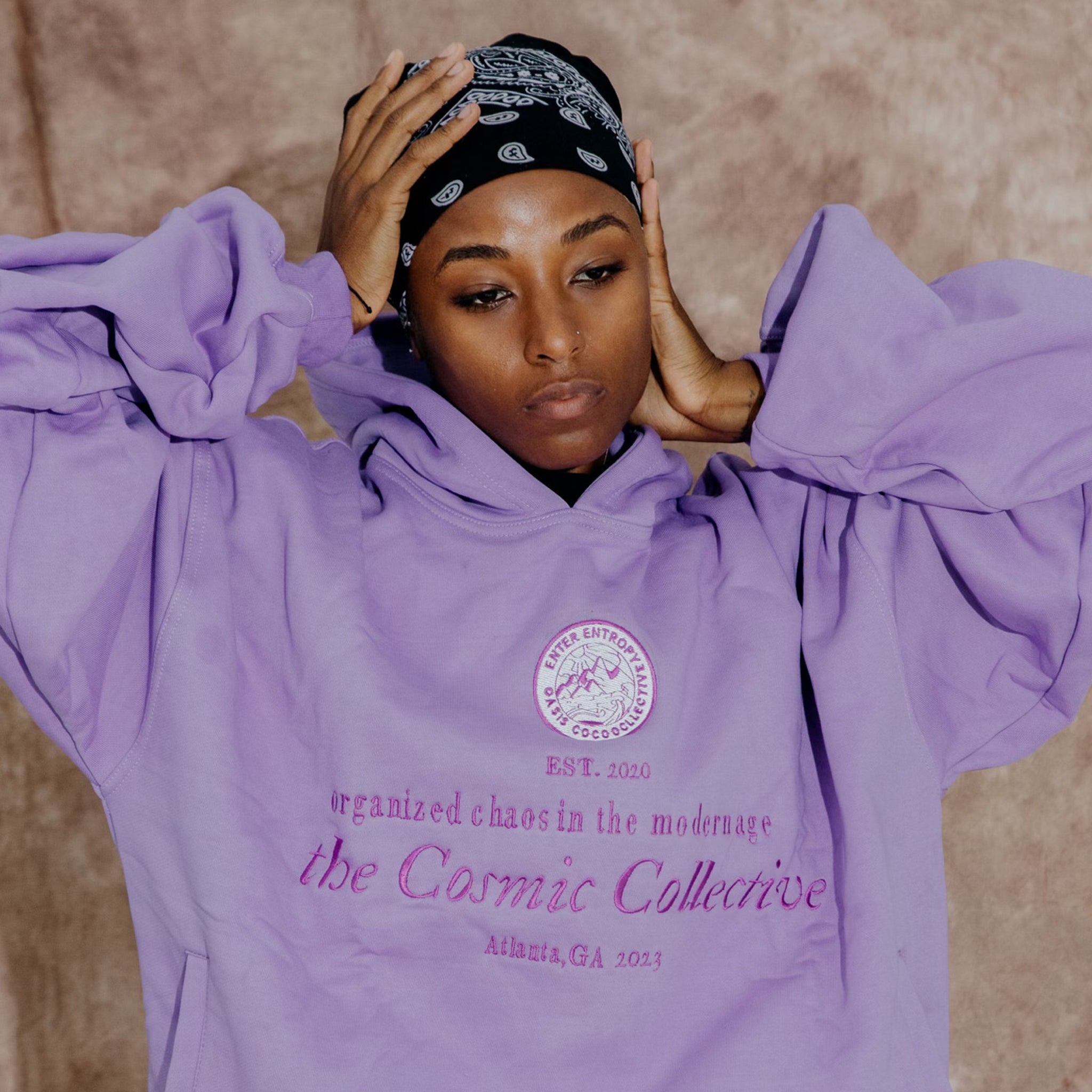 The Ube Collection features a 100% cotton purple hoodie with "Organized Chaos In the Modern Age" embroidery and slant front pockets. Forms a sweatsuit set with the Paris Heavyweight Sweatpants (sold separately).