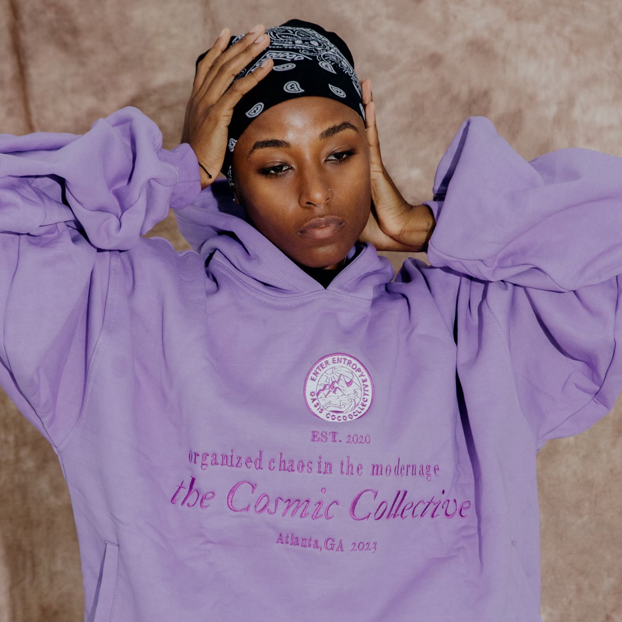 The Ube Collection features a 100% cotton purple hoodie with "Organized Chaos In the Modern Age" embroidery and slant front pockets.  Forms a sweatsuit set with the Paris Heavyweight Sweatpants (sold separately).